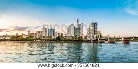 Panoramic View Of Frankfurt Am Main Skyline With Skyscrapers, Promenade And Bridge Over The Main Riv