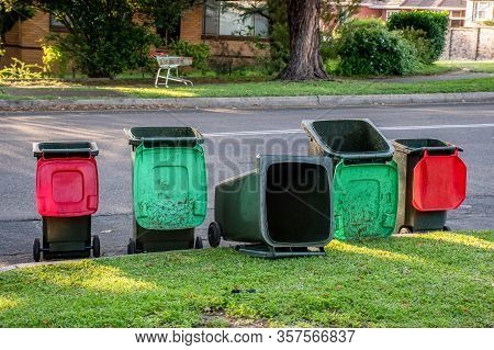 Australian Garbage Wheelie Bins Staying And Laying On A Kurb Side After Council Colleciton. Green Li