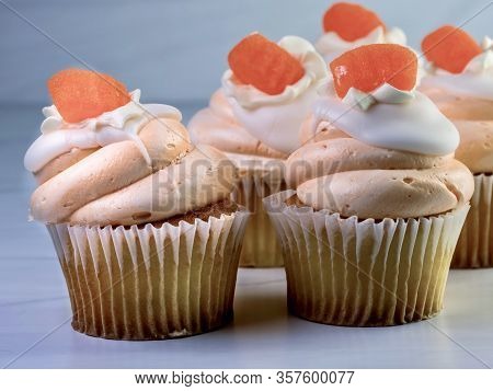 Vanilla Cupcakes With Orange And White Swirled Frosting And An Orange Candy Gumdrop On Top, Festive 