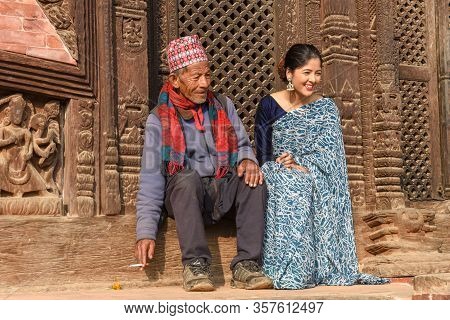 Beautiful Woman With Old Man On Traditional Clothes At Bhaktapur In Nepal