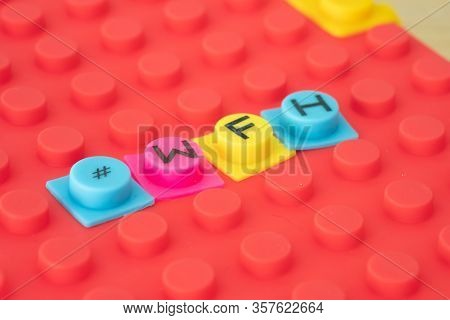 A Block Word - #wfh (work From Home). Business Concept Background