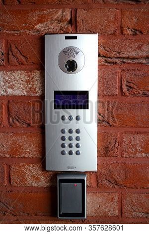 Intercom Video And Voice Connection Security System With Doorbell On A Red Brick Wall At The Entranc