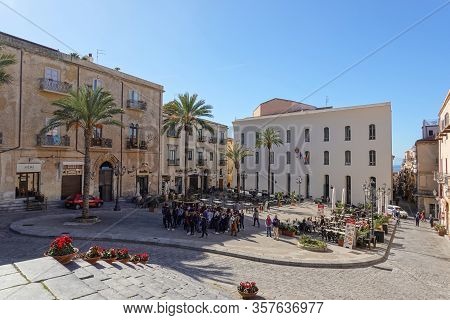 Cefalu, Sicily - February 11, 2020: Piazza Duomo With Caffeteria, Tourists And Town Council (municip