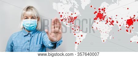 Adult Woman In A Surgical Protective Mask Shows A Stop Sign With Her Hand On The Background Of Foci 