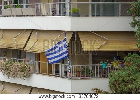 Greek Flag Waving On Balcony For A National Celebration. Blue And White Greek Flag With Cross Outsid