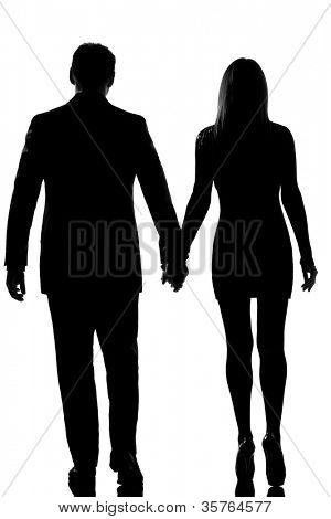 vue arrière un amoureux caucasien couple homme et femme marchant main dans la main dans l'isolat silhouette studio