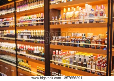Background Blurred Defocused Beers Are Cooling In Fridge, Freezer Or Refrigerator Shelf. Defocused B