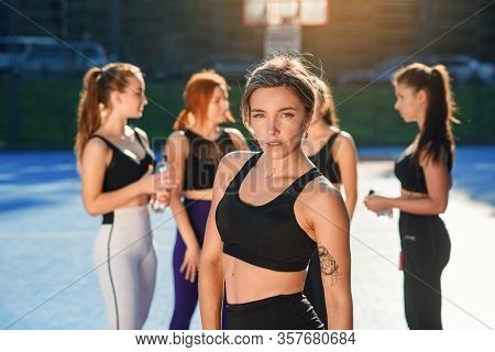 Front View Of Charming Smiling Sporty Slim Lady Looking At Camera After Ending Her Sport Training On