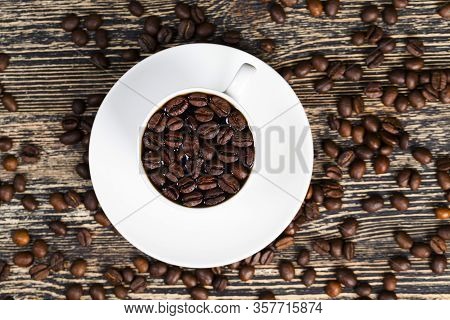 Beautiful Roasted Coffee Beans With Warm Freshly Made Coffee In A White Cup, Whole Grains For Making