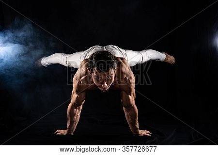 Muscular Man Making Planche On Black Black Background