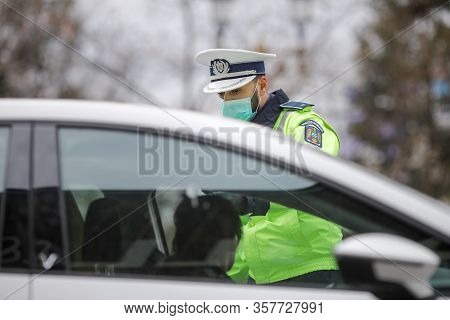 Romanian Road Police Officer Pulls Over A Car To Check For The Driver’s Identity Papers.