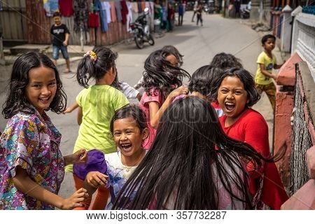 Panyambungan, Indonesia - June 21, 2018: Children Excited And Afraid Of Camera Running Away On The S