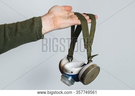 Respirator In Male Hands. The Concept Of Protection Against Viruses And Diseases. Virus Worldwide Co