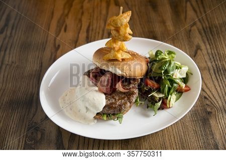 Burger Of Beef Meat With Melted Chedar Cheese, Bacon,tomato, Rocket Salad With Spicy Fries On The Ta