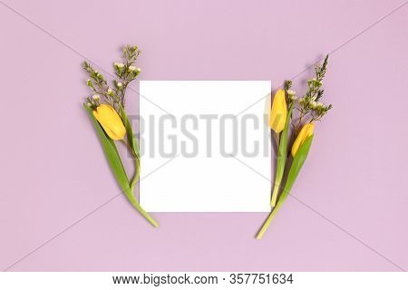 Frame Made Of Flowers On A Purple Pastel Background. Square Paper Card Mockup. Spring Concept.