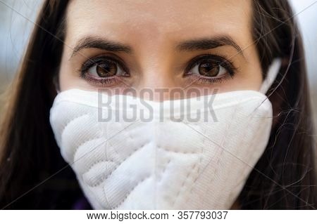 Young Woman Wearing A Protective Surgical Face Mask During The Coronavirus Disease Covid 19 Outbreak