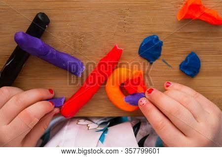 .child Playing With Plasticine And Making Molds