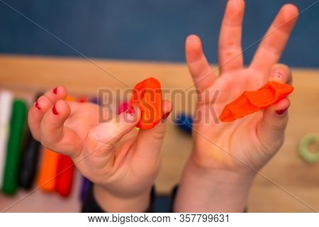 .child Playing With Plasticine And Making Molds