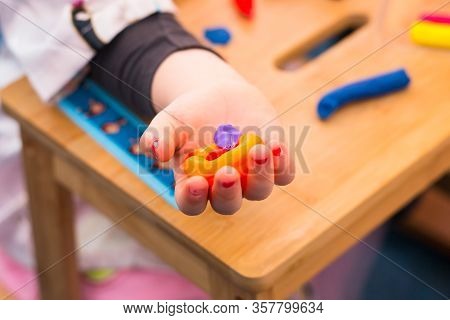 .child Playing With Plasticine And Making Molds