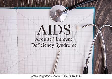 Page With Aids Acquired Immune Deficiency Syndrome On The Table With Stethoscope, Medical Concept
