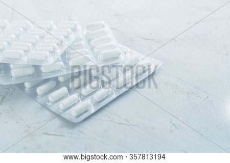 Three Blister Of Pills Closeup. Oval Long Medecines. Horizontal. Background Or Texture About Medicin