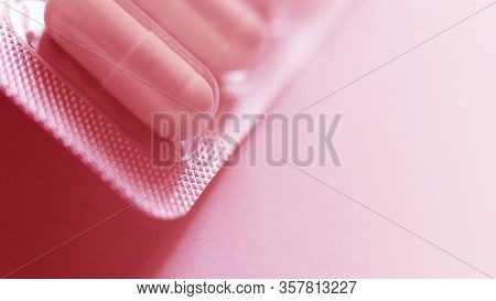 One Blister Of Pills Macro. Oval Long Shape Remedies. Red Tone, Sun Fleck. Background Or Texture Abo