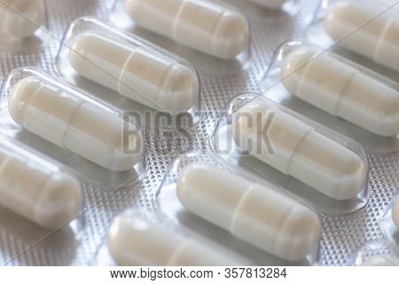 Pack Of Pills Closeup. Diagonal Row Of Oval Long Shape Remedy. Background Or Texture About Medicine,