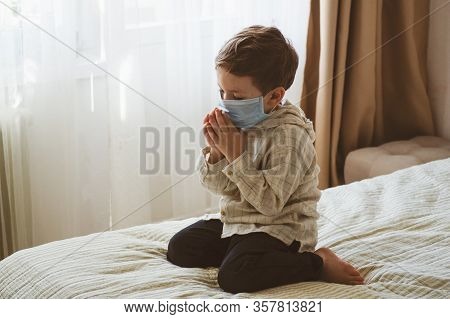 Coronavirus Covid-19. Child Praying To God Requesting That The Coronavirus Covid 19 Not Spread Beyon
