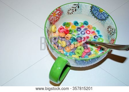 Close Up Of A Bowl Full Of Fruit Flavored Loops Of Sugar Ready To Eat Breakfast Cereal With A Spoon 