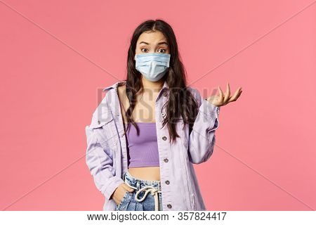 Covid19, Quarantine, People Concept. Surprised Young Woman In Medical Face Mask Stay Safe During Cor
