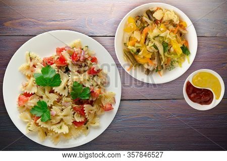 Pasta On A White Plate. Pasta Tomatoes, Onions, Cabbage On A Purple Wooden Background. Pasta With Ve
