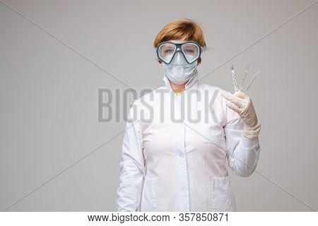 Paramedic With Three Thermometers. Stock Photo Portrait