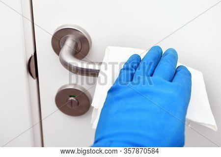 Disinfection In Public Places, The Fight Against The Virus, Coronavirus.worker's Hand Wipes The Door