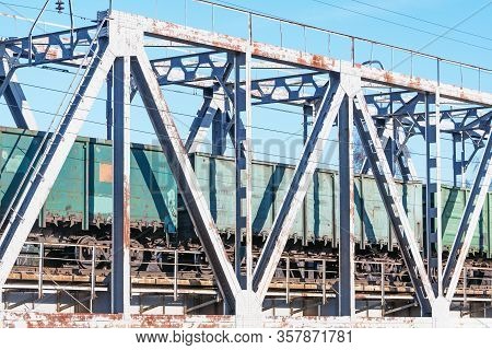 Freight Train Moves On The Metal Bridge.