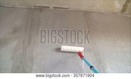 Paint The Bare Wall With A Paint Roller. Hand Painted By Roller. Primer Wall Roller