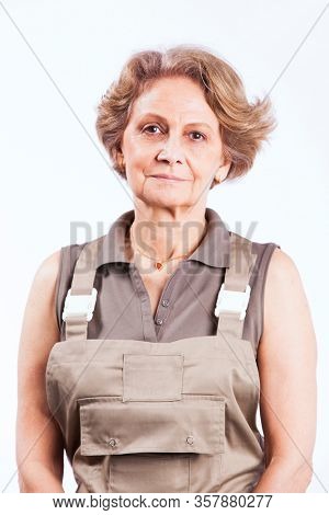 Happy senior woman with construction clothes (isolated on white)