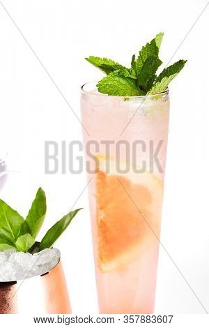 Breakfast fizz cocktail close up. Alcohol strong drink in glass side view. Beverage with gin, egg white and fruits in drinkware. Cocktail portion decorated with berries in glassware
