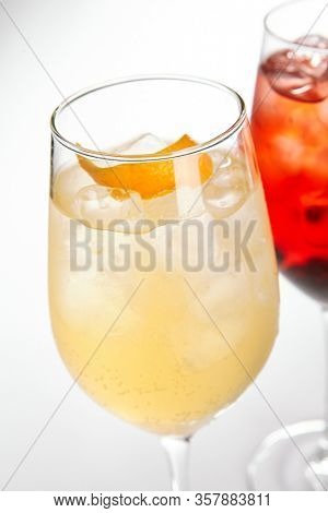 Peach Spritz cocktail. Alcohol soft drink in glass side view. Refreshment beverage with fruit puree in drinkware. Exotic summer beach cocktail portions with crushed ice in glassware