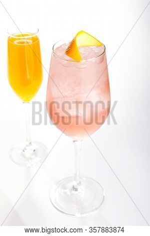 Raspberry french cocktail close up. Alcohol drink in glass top view. Beverage with rose gin and prosecco wine in drinkware. Exotic French Martini cocktail portion with crushed ice in glassware