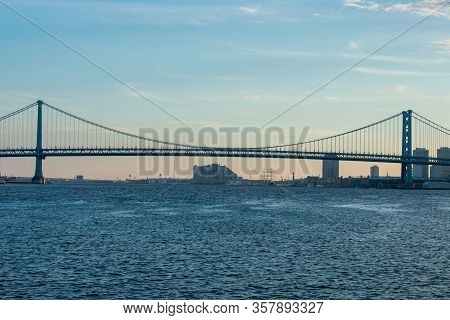 The Ben Franklin Bridge At Sunset Over The Deleware River