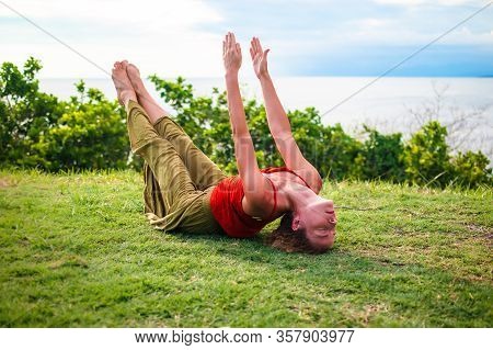 Outdoor Yoga Practice. Young Woman Practicing Matsyasana. Fish Pose Is A Reclining Back-bending Asan
