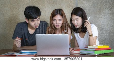 Asian Young Man And Woman Sitting Pointing Studying Examining, Tutor Books With Friends Young Studen