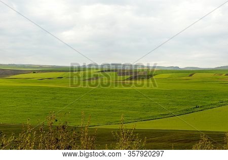 Panoramic View Of Geometric Patchwork Of Gardens, Agricultural Lands, Farmland In Springtime
