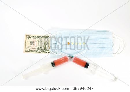 Vaccine Syringes And Medical Masks On Banknotes