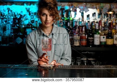 Beautiful Woman Bartender Holds Glass With Rose Cocktail