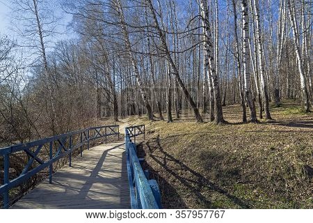 A Pedestrian Bridge Laid The Bottom Of A Small Ravine. Landscape Reserve 