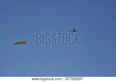 Matalascanas, Spain - July 10, 2011:light Aircraft With Ads Above The Beach In The Resort Town Of Ma
