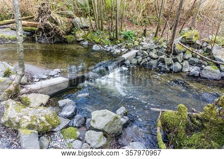 Water Flows Over A Barrier In Des Moines Cree In Washington State.