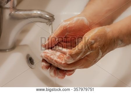 Man Wash His Hands With A Soap. Washing Hands Frequently With Soap And Hot Water For Coronavirus Out
