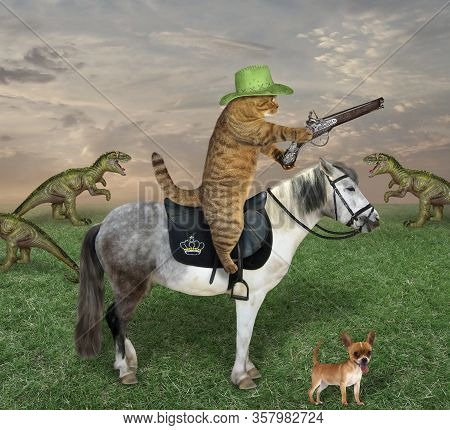 The Beige Cat In A Cowboy Hat With His Dog Grazes A Herd Of Dinosaurs On The Farm. He Has An Antique